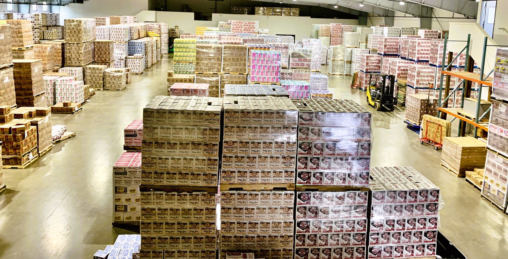 A large warehouse filled with lots of boxes and pallets.