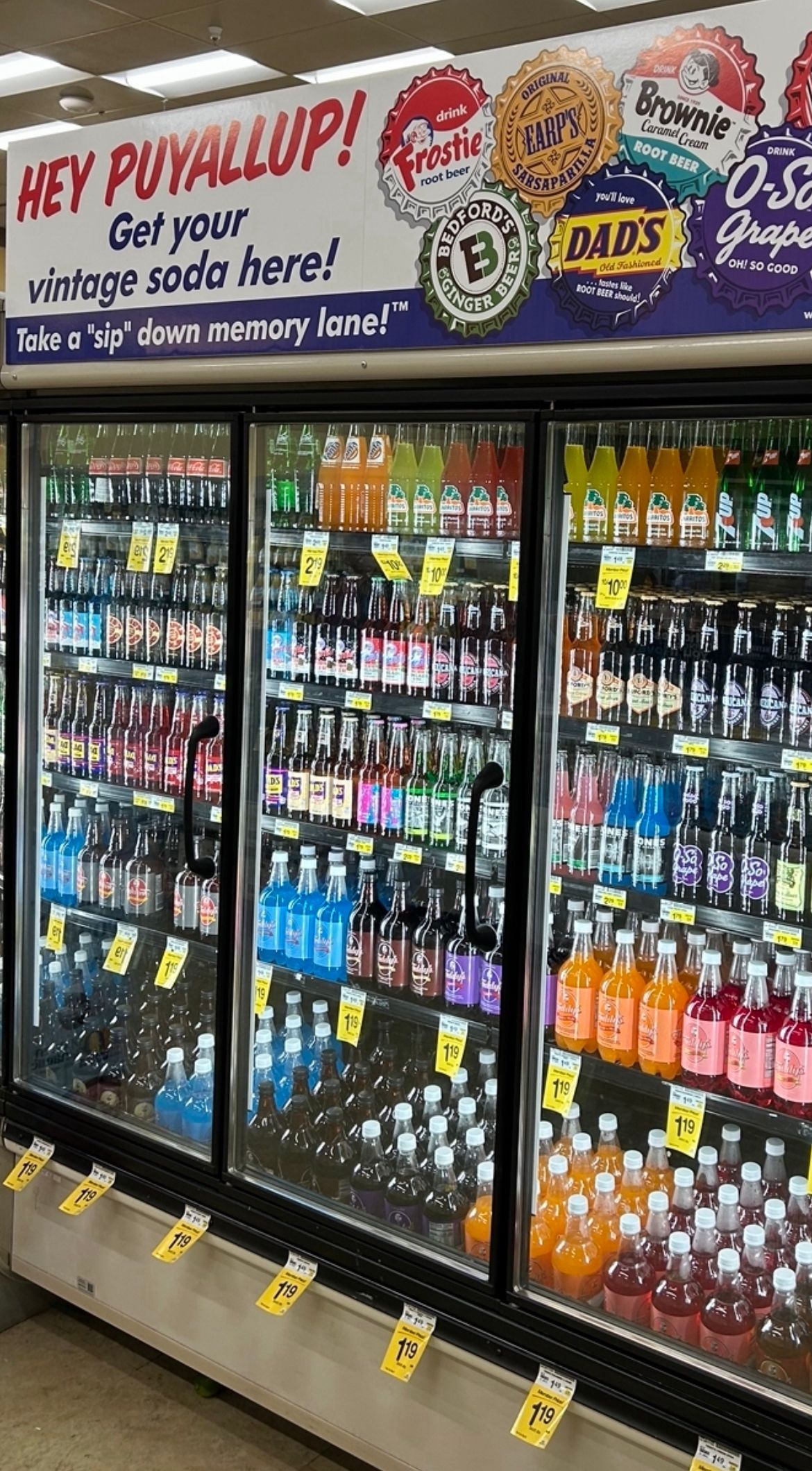 A refrigerator filled with lots of drinks in a store.