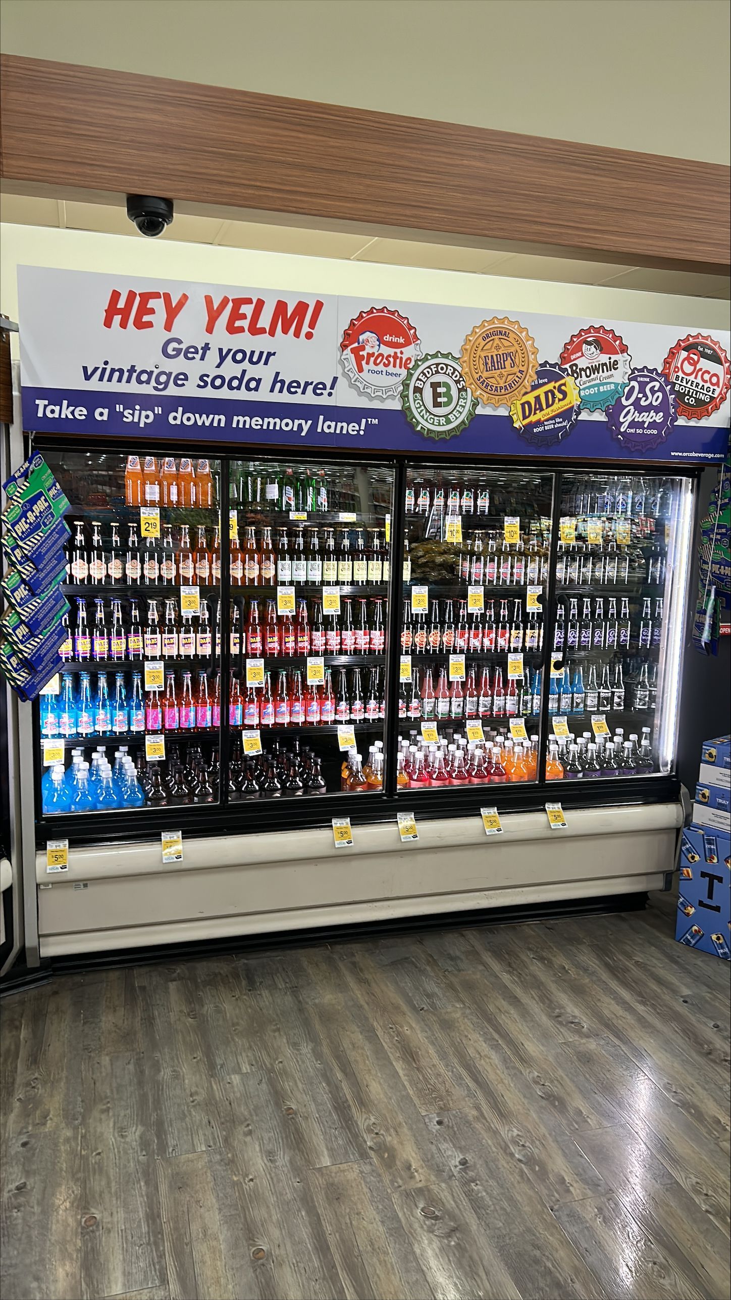 A refrigerator filled with lots of drinks in a grocery store.