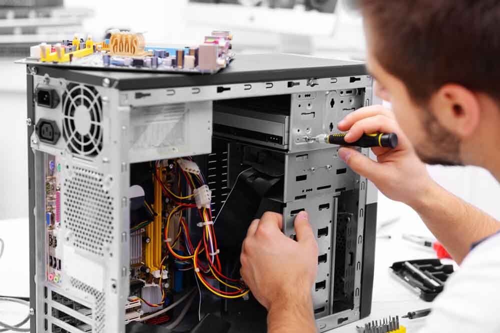 IT technician repairing desktop - computer repairs Charmhaven