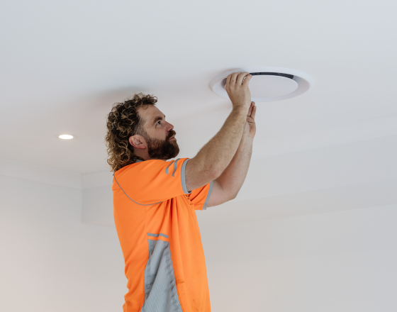 Win Air & Electrical team member installing air vent.