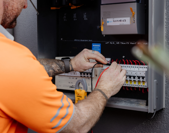 Win Air & Electrical team member fault fixing an electrical switch board.