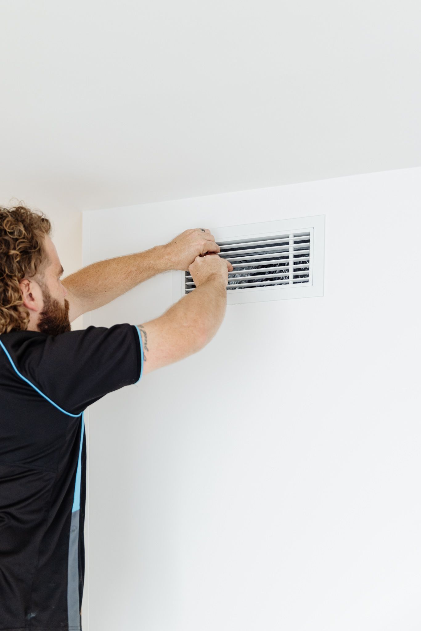 Win Air & Electrical team member conducting electrical work outside of clients home.