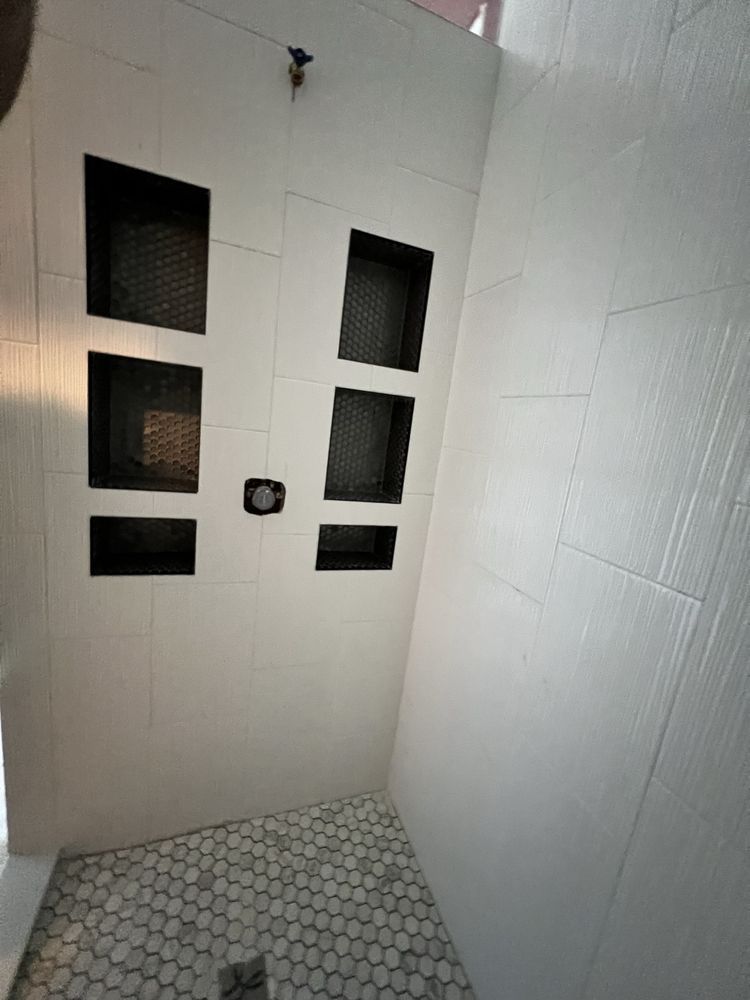 A man in a plaid shirt is using a laptop