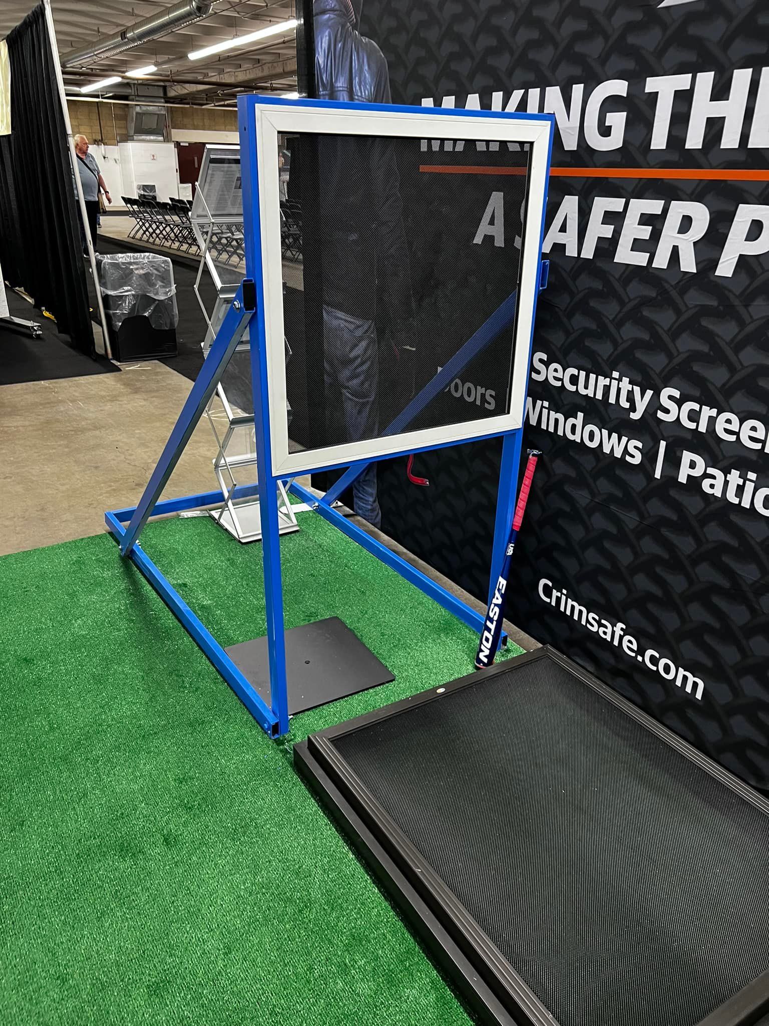 Blue metal frame with security screen. Sign says “Crimsafe” and “Safer Place.”