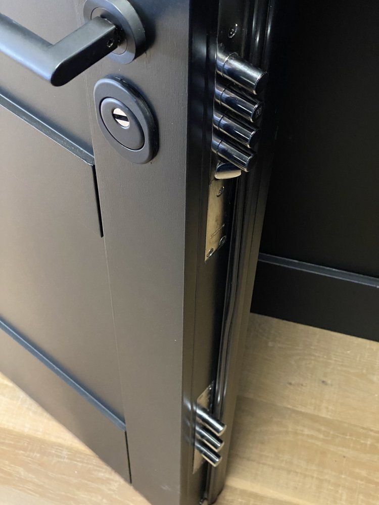 Black door with security locks and handle.