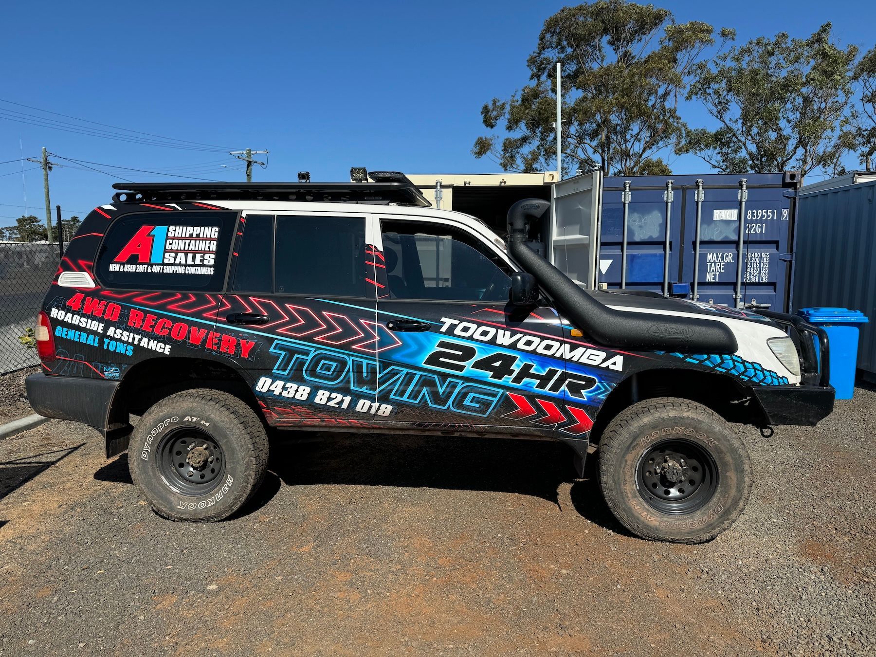 Tow Truck With a Trailer Attached to It is Parked in a Gravel Lot — Toowoomba 24hr Towing In Toowoomba, QLD