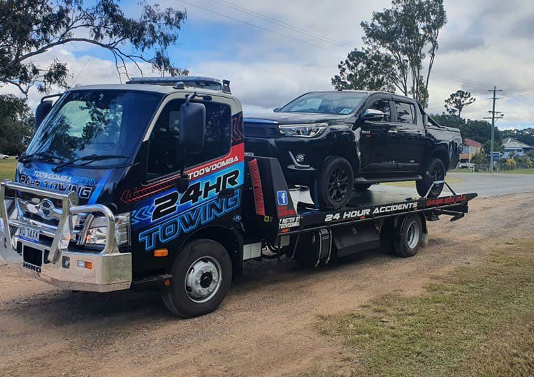 Towing Truck Carries The Black Pick Up Vehicle — Toowoomba 24hr Towing In Toowoomba, QLD