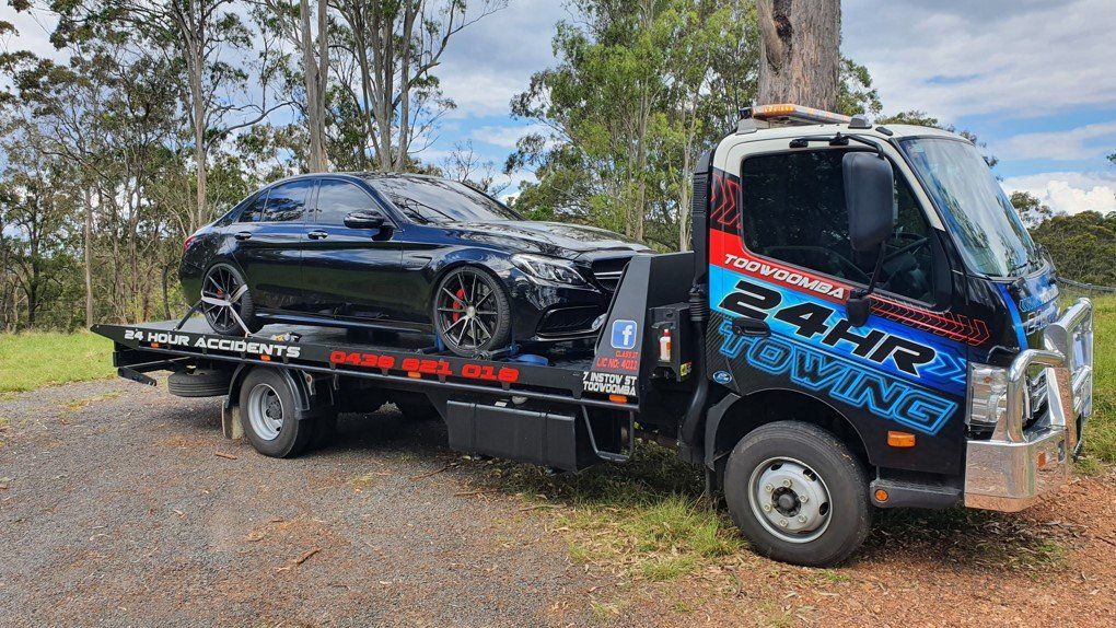 Towing  Truck Loaded with A Black Car — Toowoomba 24hr Towing In Toowoomba QLD