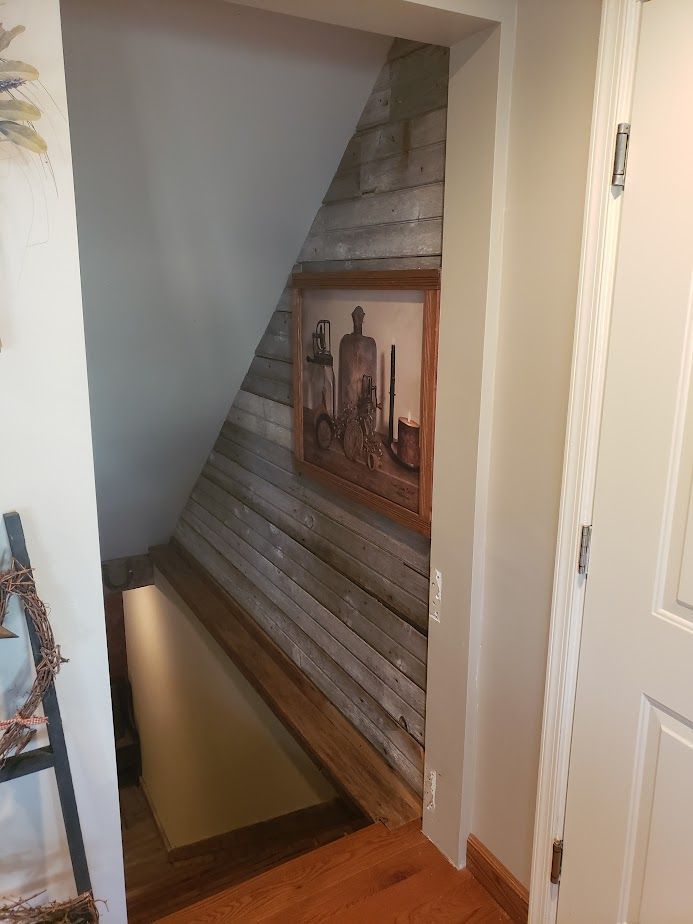 A doorway leading to a staircase with a picture on the wall.
