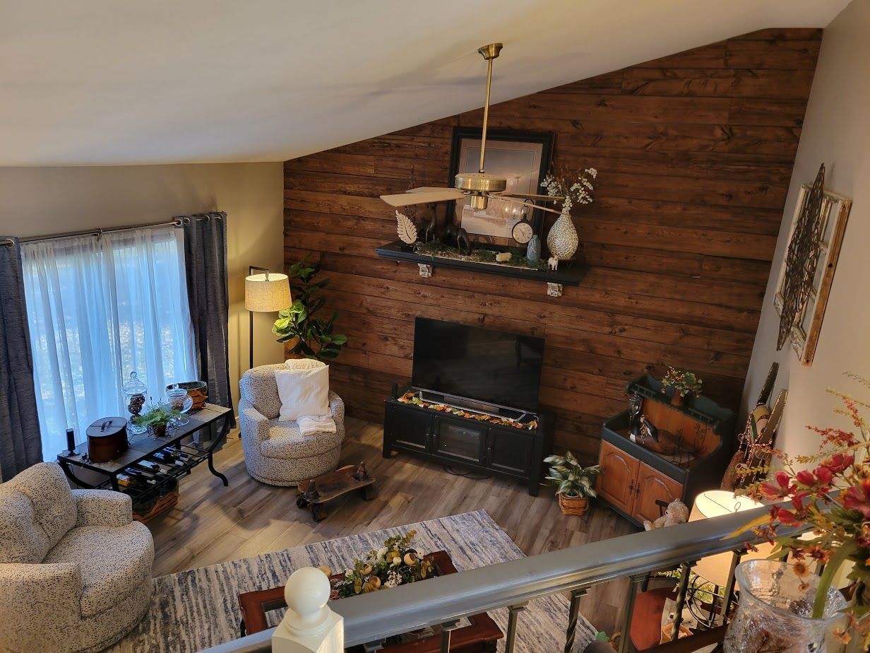 An aerial view of a living room with a fireplace and a television.