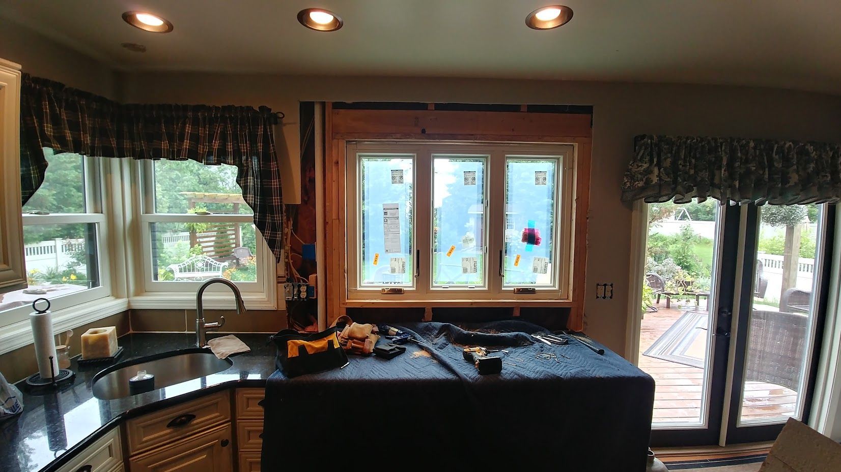 A kitchen with a lot of windows and a sink