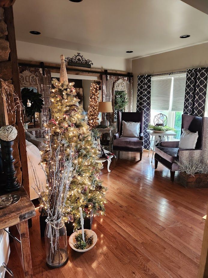 A living room filled with furniture and a christmas tree.