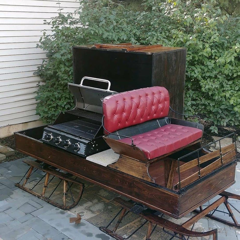 A wooden wagon with a red couch on top of it