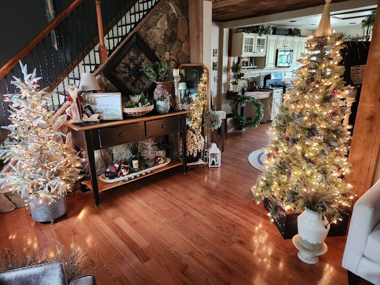 A living room filled with christmas trees and decorations.