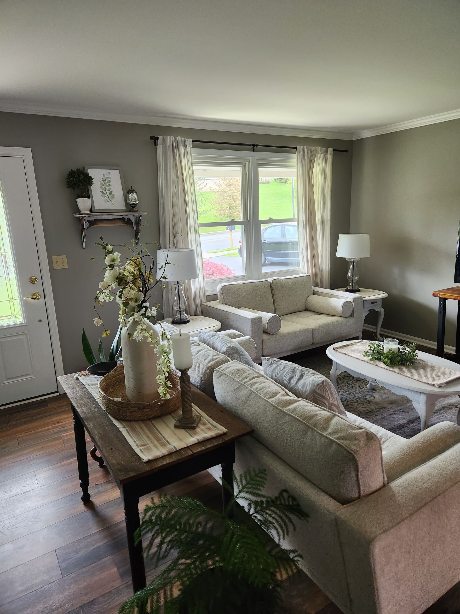 A living room with a couch , table , and lamps.