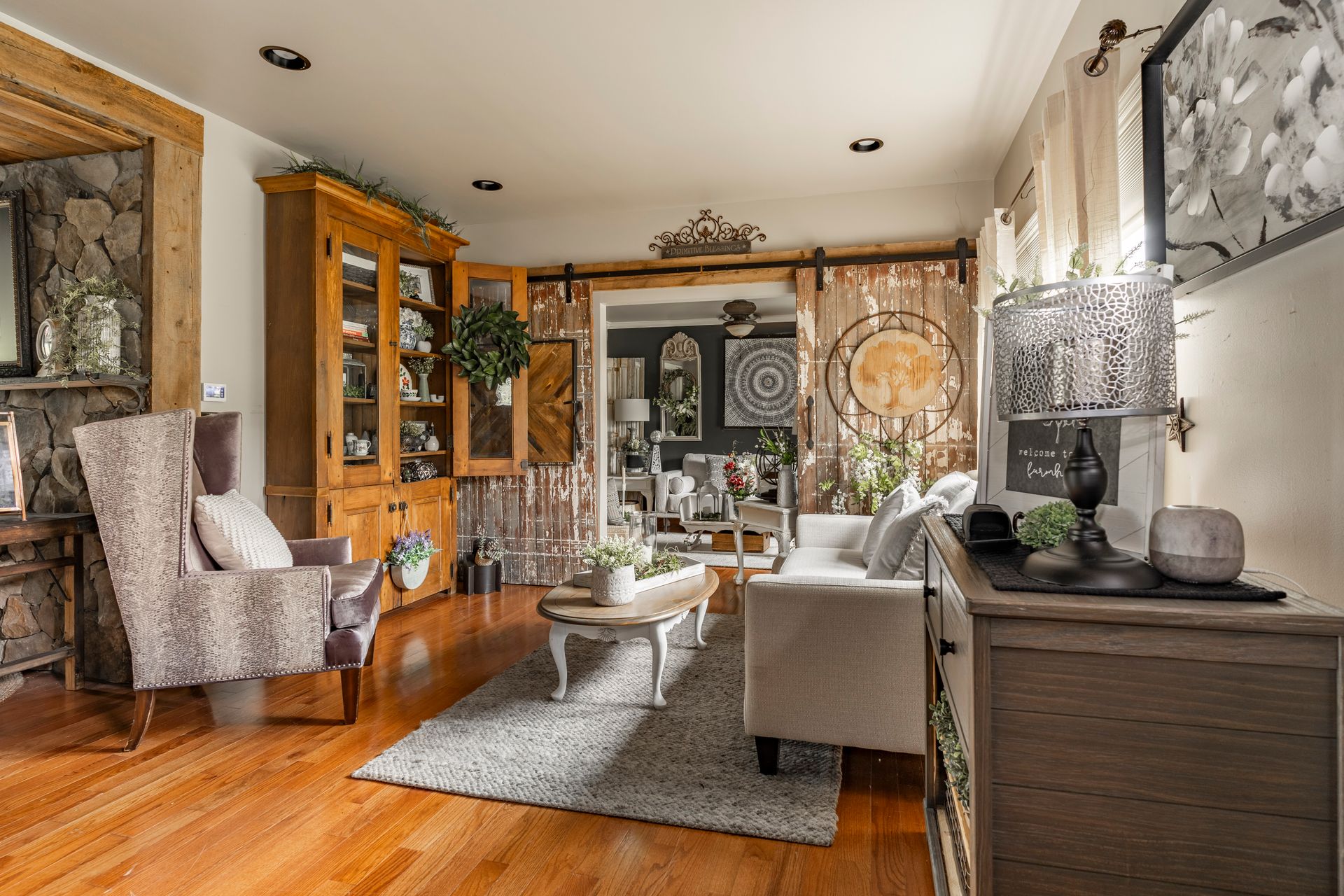 A living room filled with furniture and a sliding barn door.