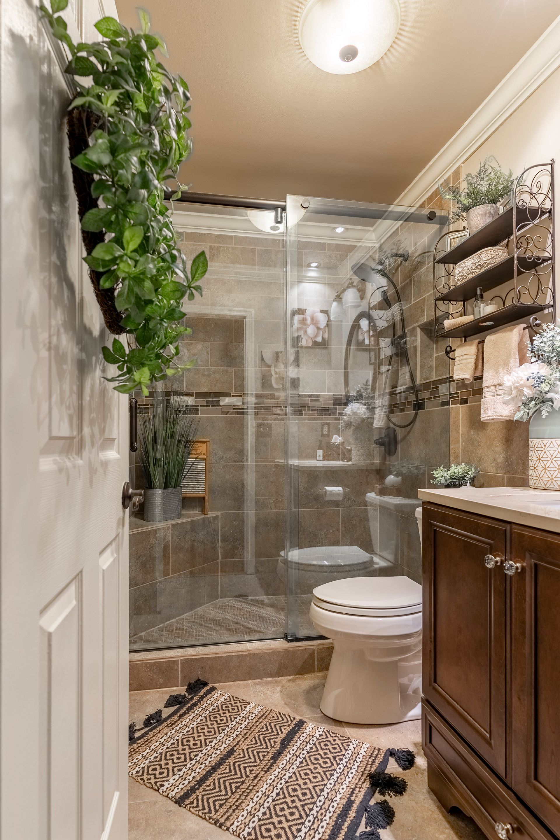 A bathroom with a toilet , sink , and shower.