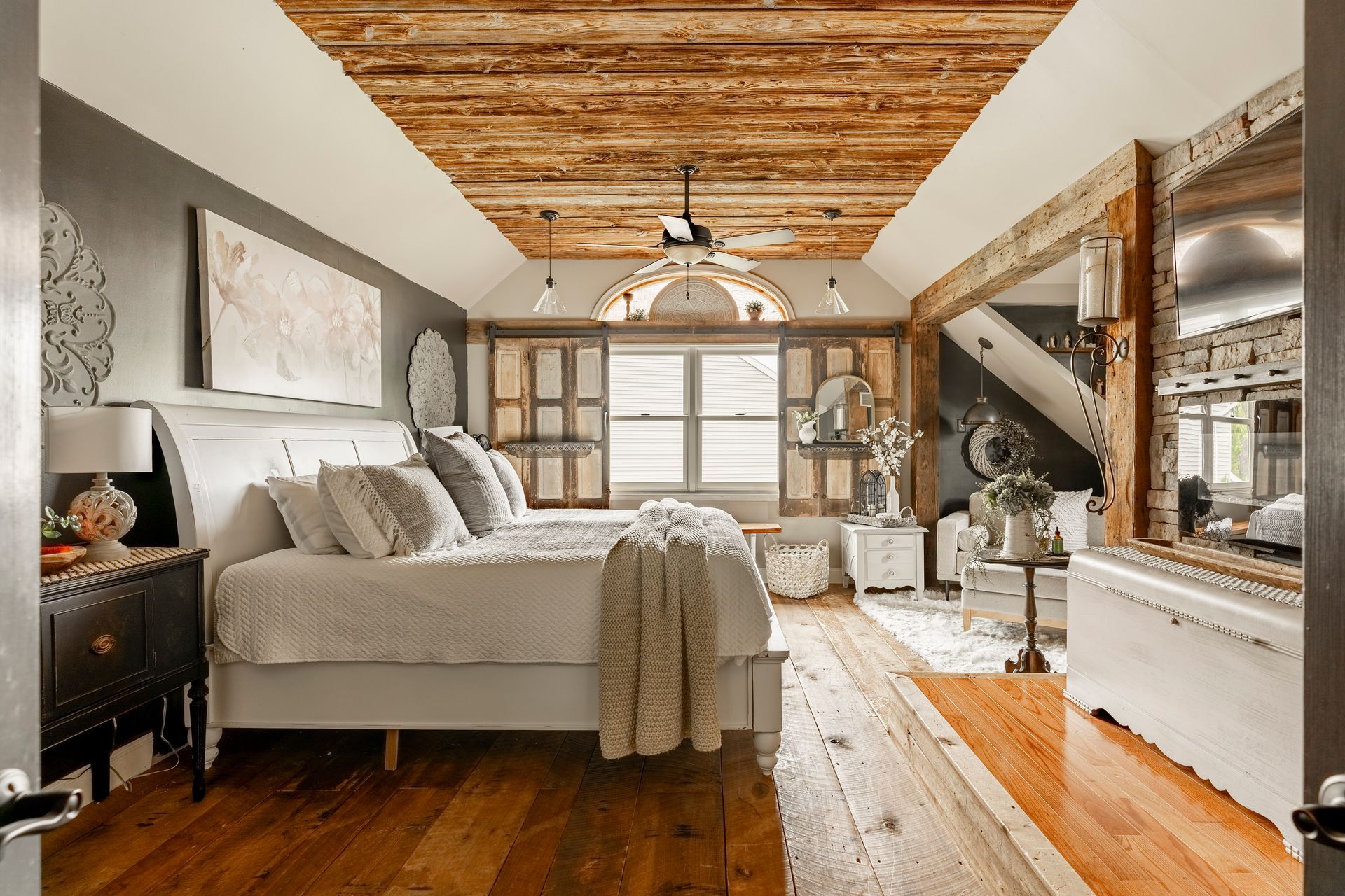 A bedroom with two beds and a wooden floor