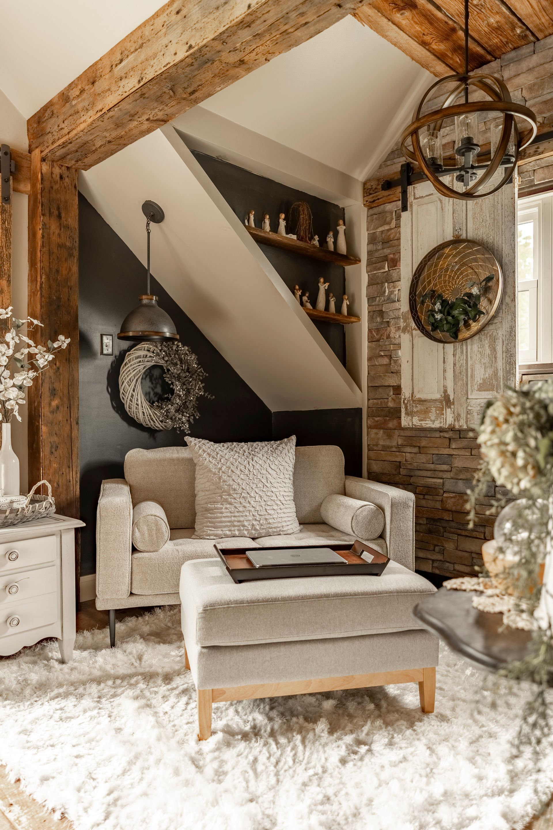A living room with a couch , chair , ottoman and rug.