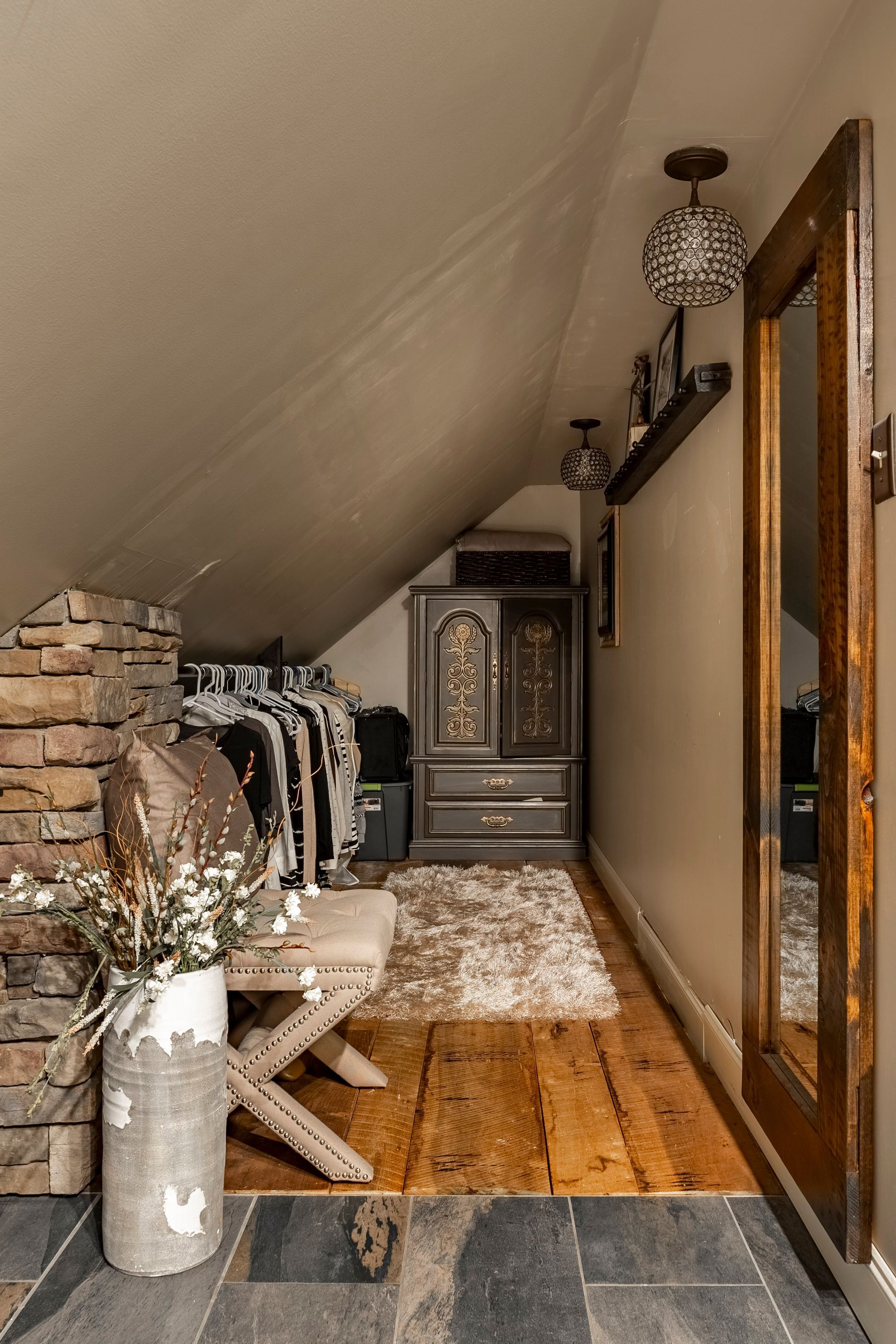 A hallway with wooden floors and a large mirror.