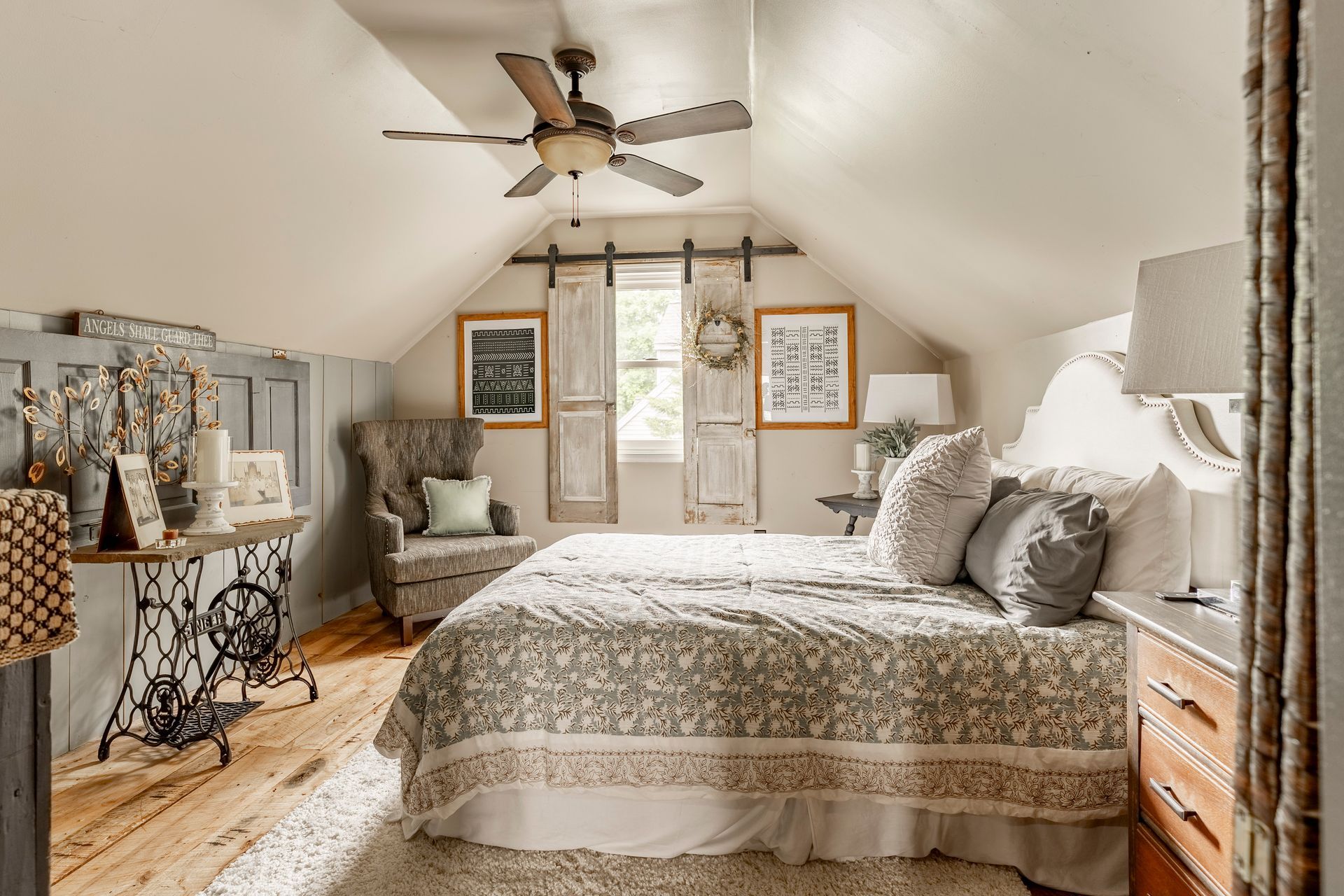 A bedroom with two beds , a chair and a ceiling fan.