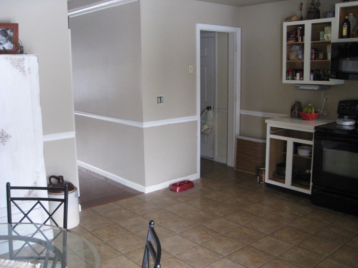 A kitchen with a table and chairs and a stove