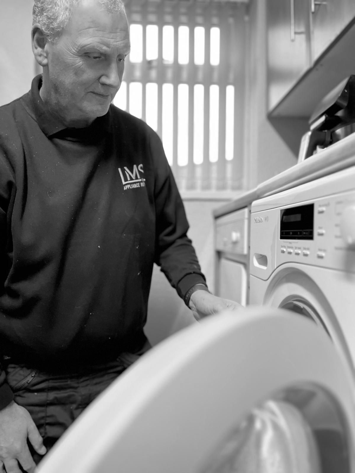 Martin is draining a Miele washing machine in a house in Bristol