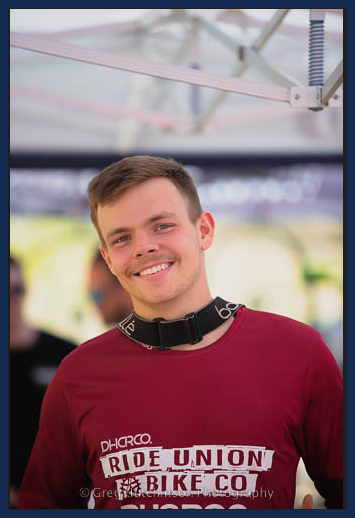 A man wearing a red shirt that says ride union bike co
