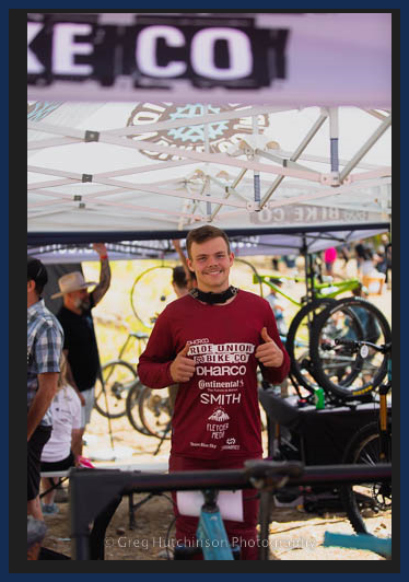 A man wearing a maroon shirt with the word smith on it