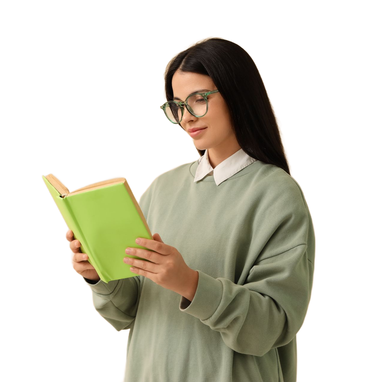 A person wearing glasses and a sage green sweater stands against a white background, holding and reading a lime-green book.