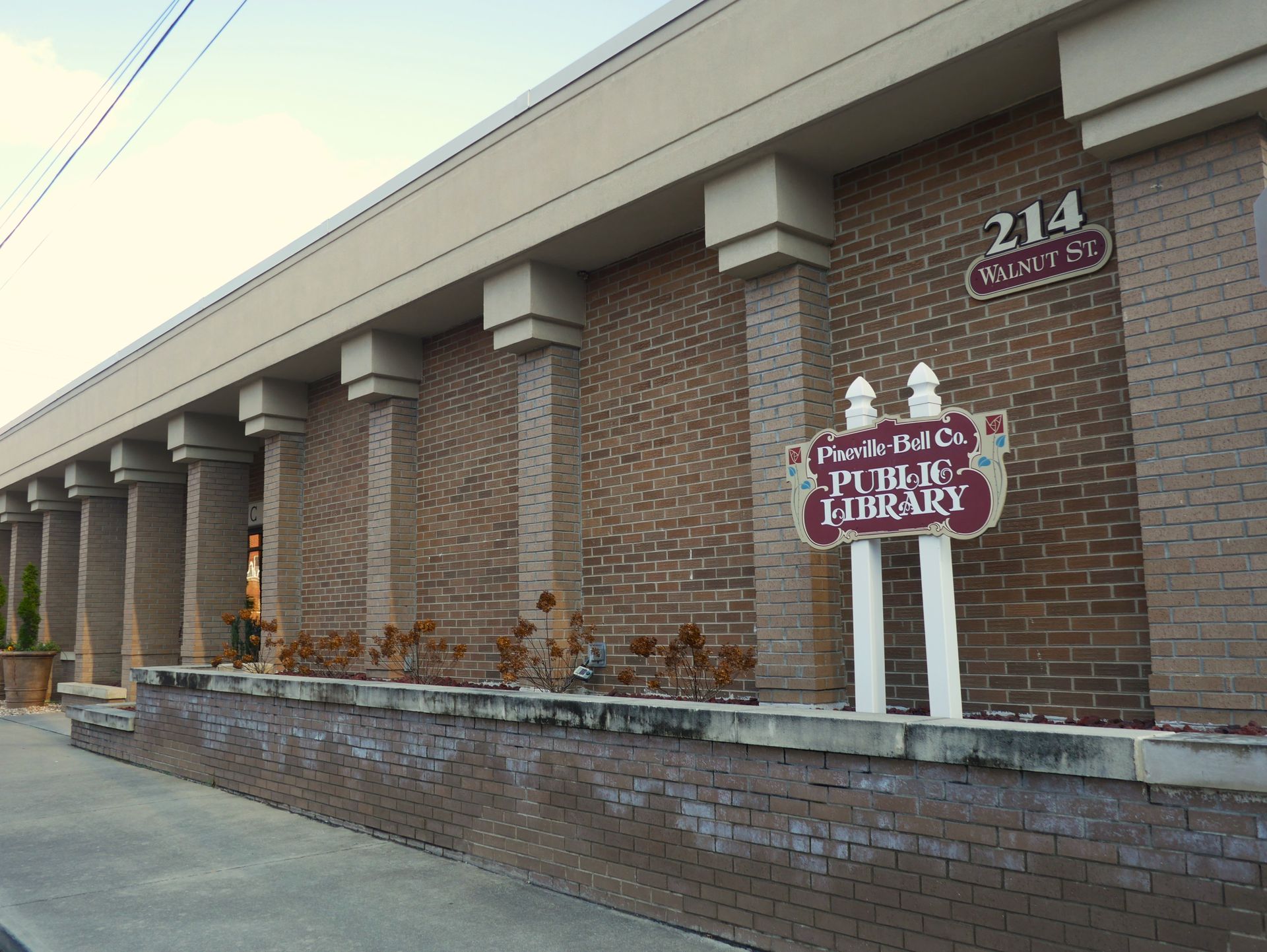 A brick building exterior with a sign reading 