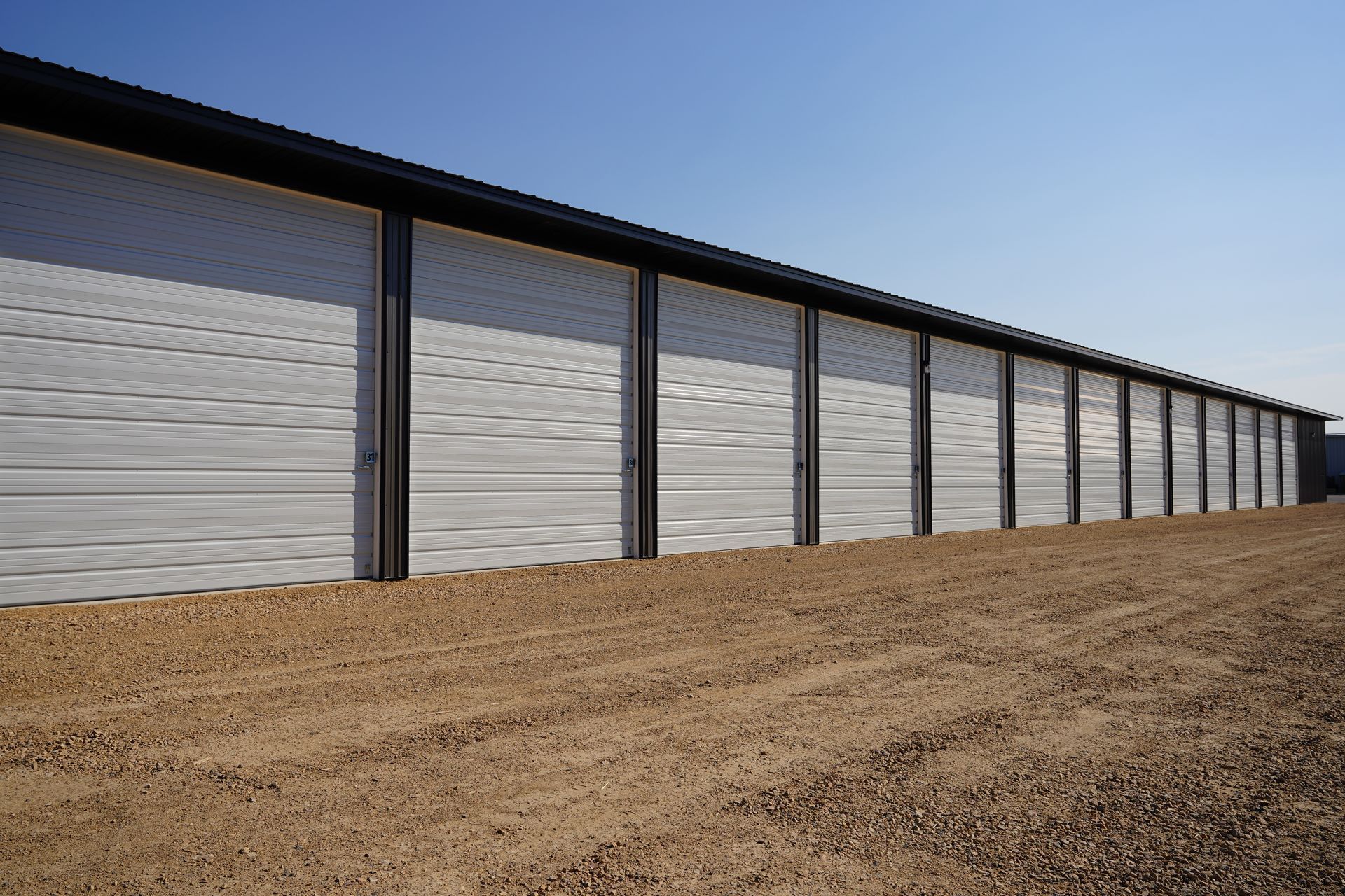 Grey and white door storage units on the roadside.