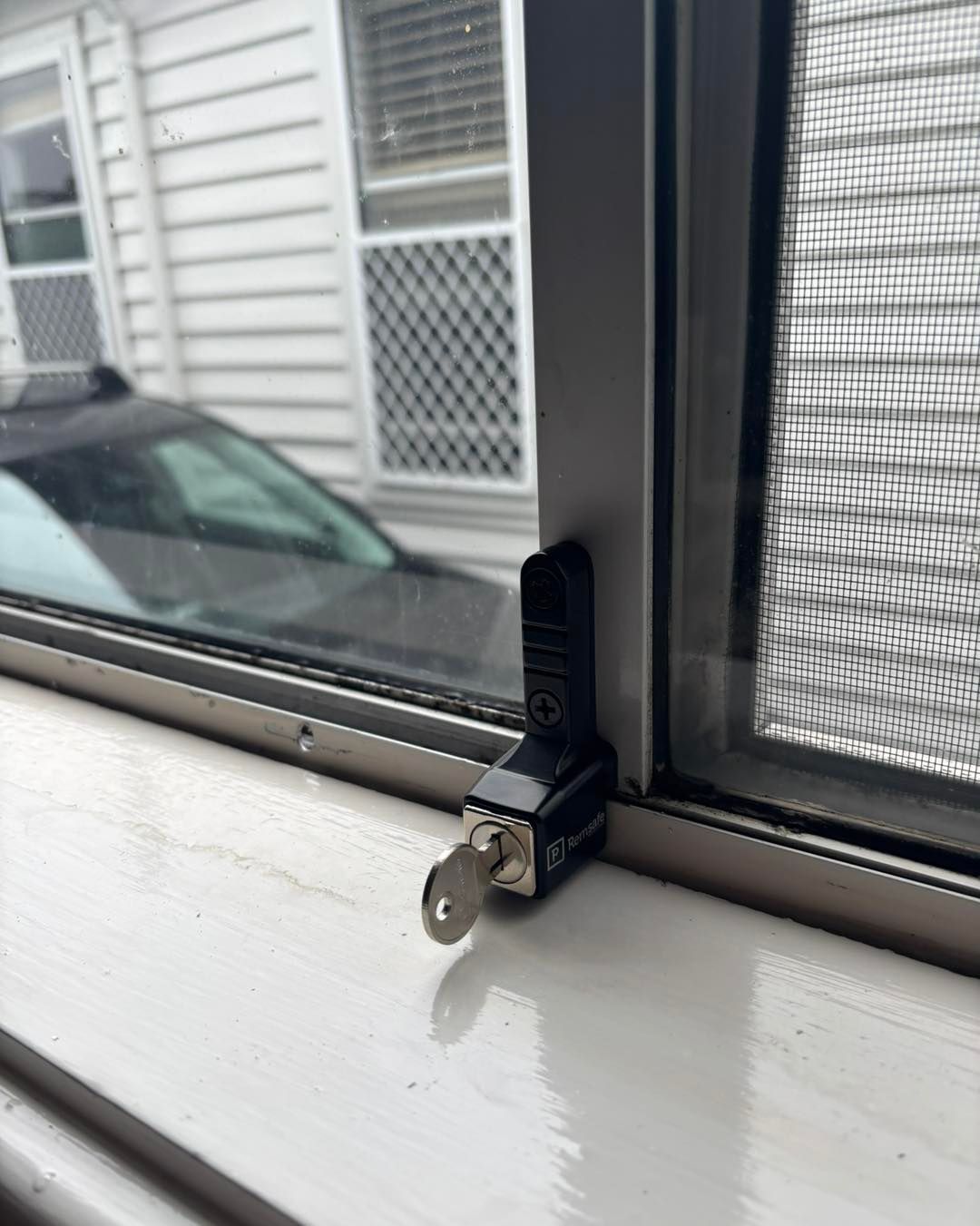 A Window With a Black Lock, Key Inserted, on a White Sill — Fix-A-Door in Morisset, NSW