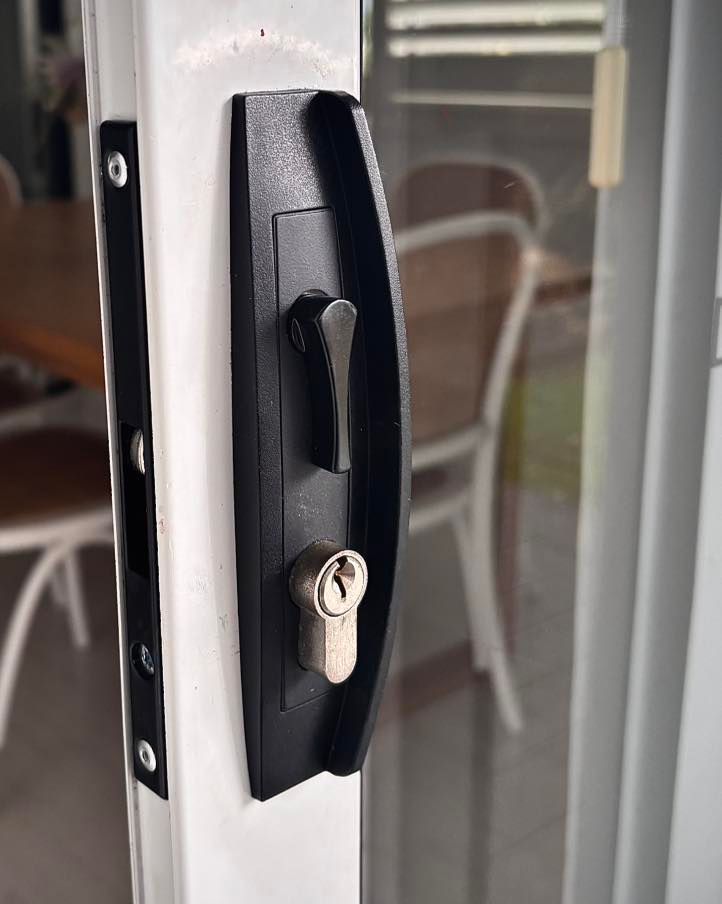 Black Door Handle With Lever and Keyhole on White Door Frame, Interior Background — Fix-A-Door in Morisset, NSW