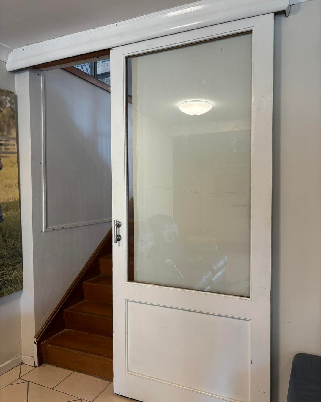 White Sliding Glass Door Beside a Wooden Staircase, Leading to Another Room — Fix-A-Door in Morisset, NSW