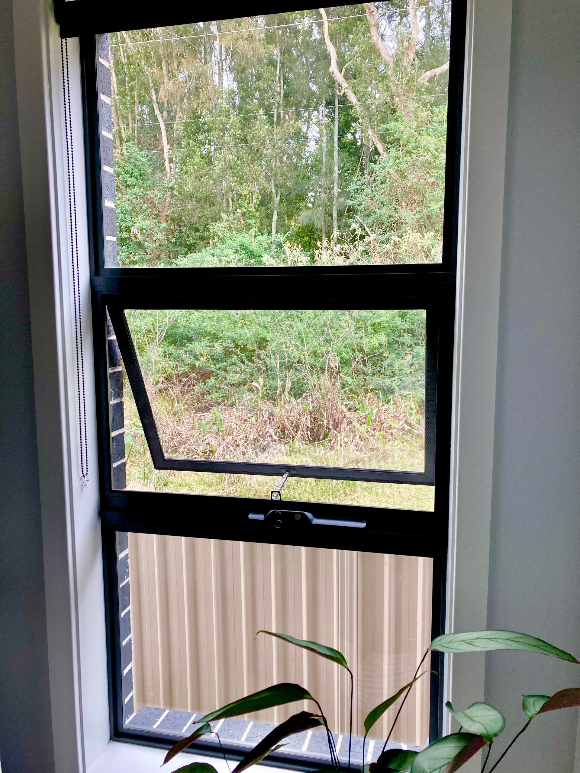 Black-framed, Open Awning Window Reveals Green Foliage — Fix-A-Door in Wyong, NSW