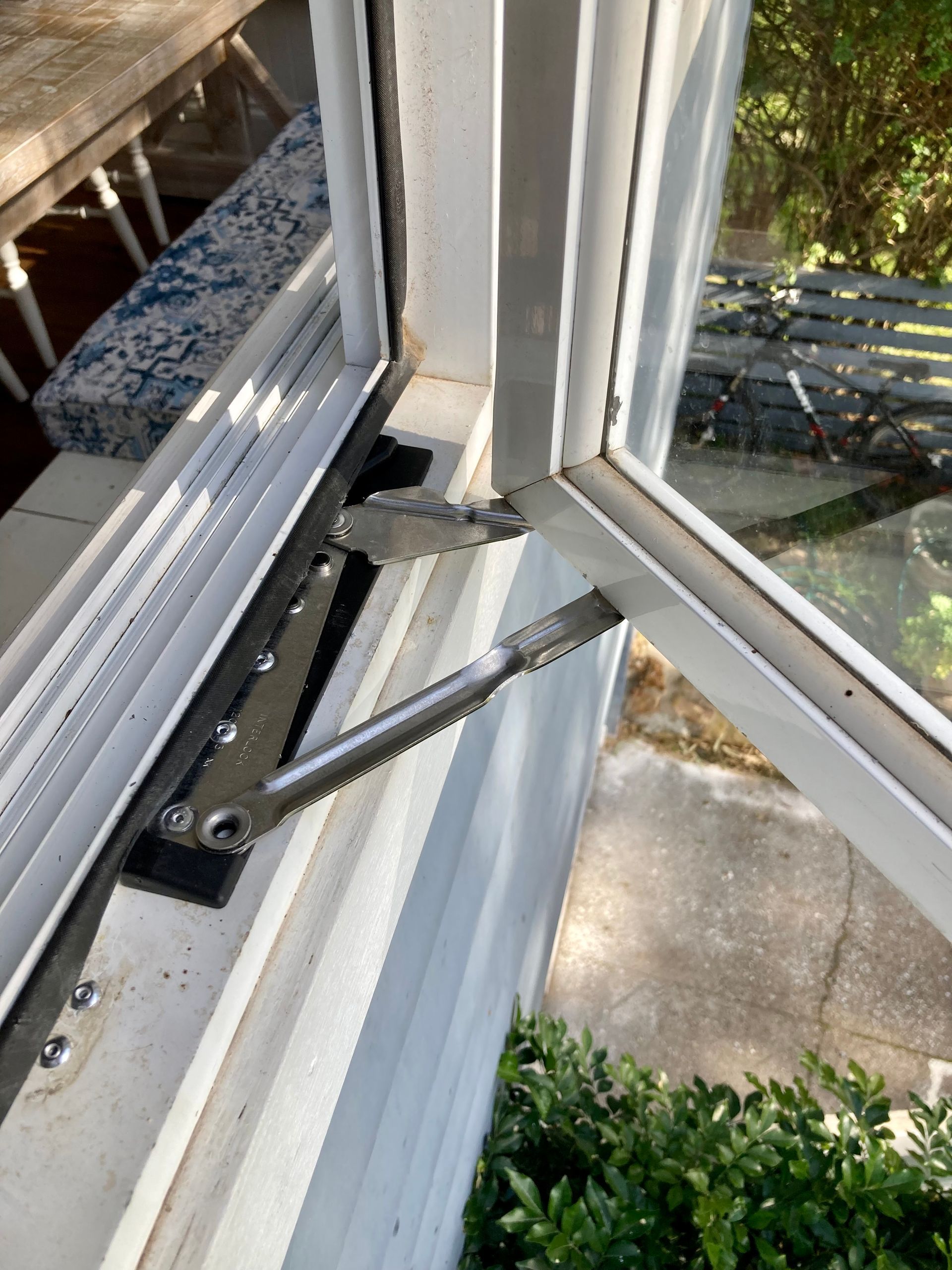 Opened white window with silver hardware, showing an exterior view-Fix-A-Door in Morisset, NSW
