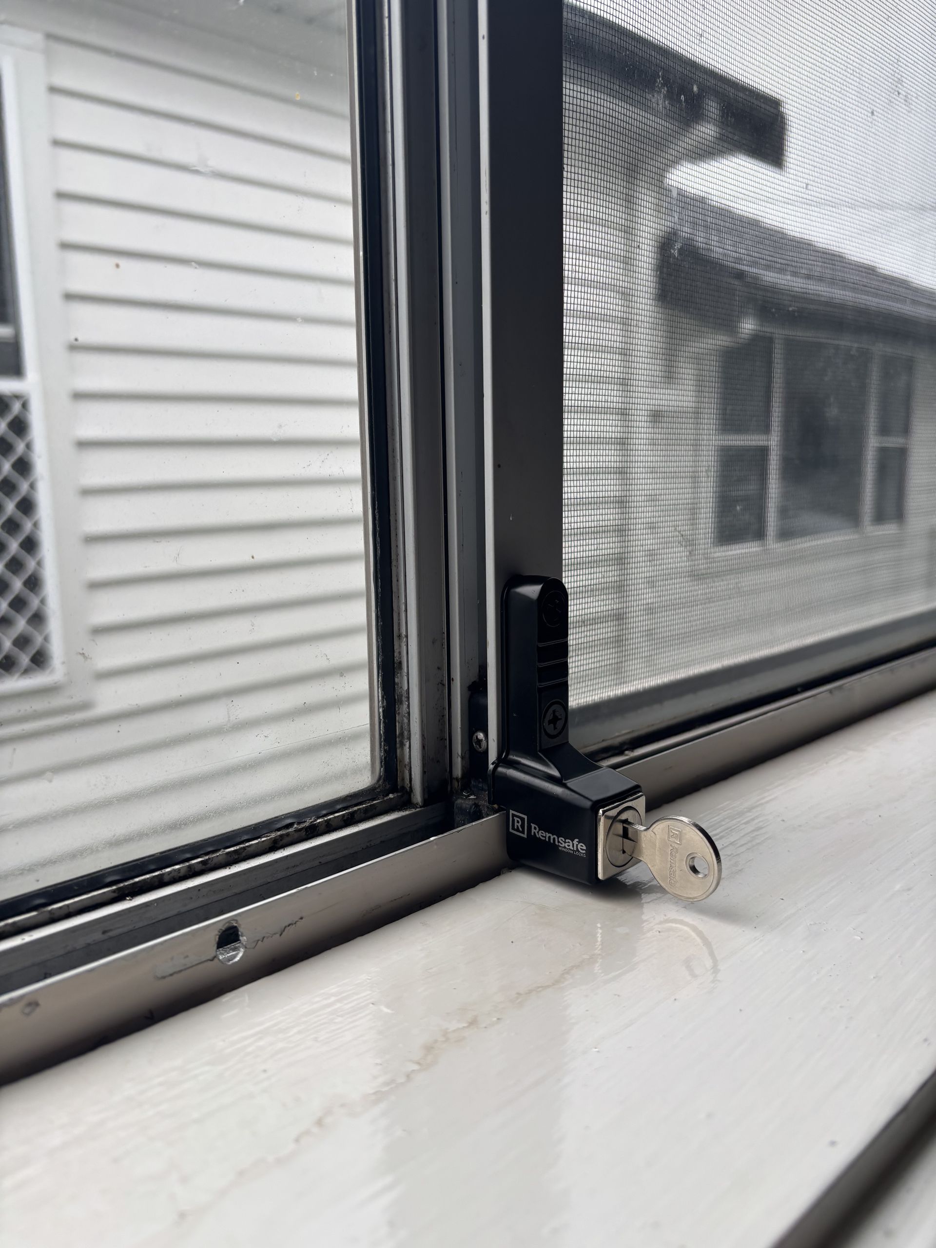 Close-up Of A Window With A Screen And A Keyed Lock — Fix-A-Door in Cessnock, NSW