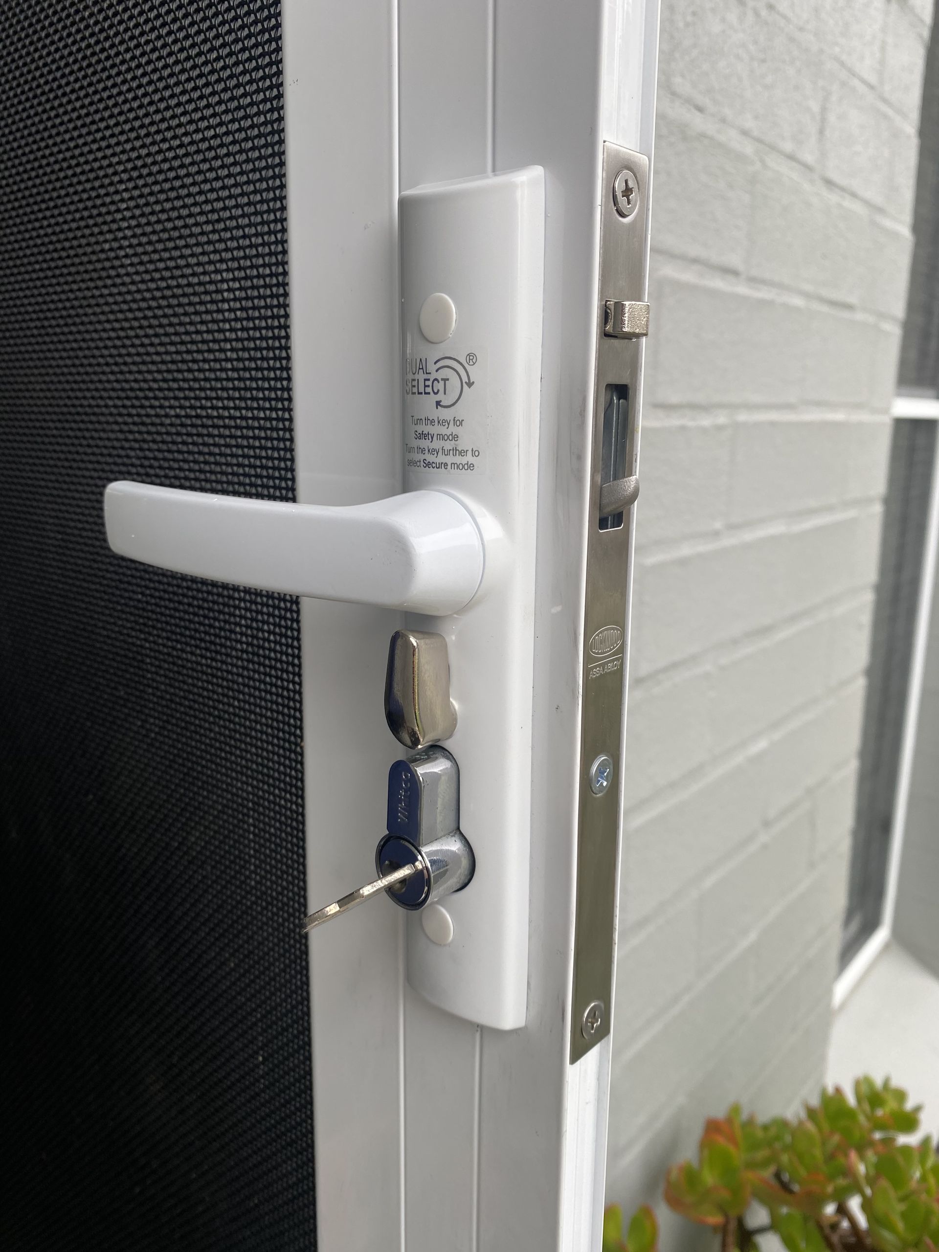 White Security Door With Keys In The Lock — Fix-A-Door in Raymond Terrace, NSW