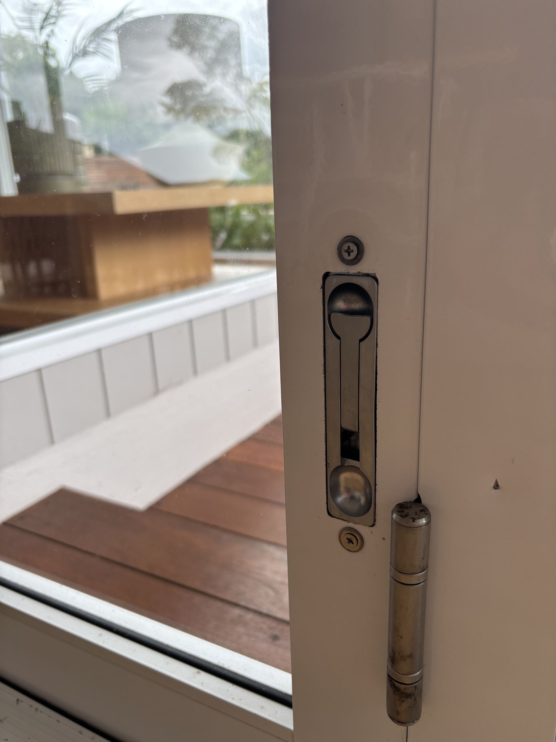 Close-up Of A White Door With A Silver Sliding Lock And Hinge — Fix-A-Door in Raymond Terrace, NSW