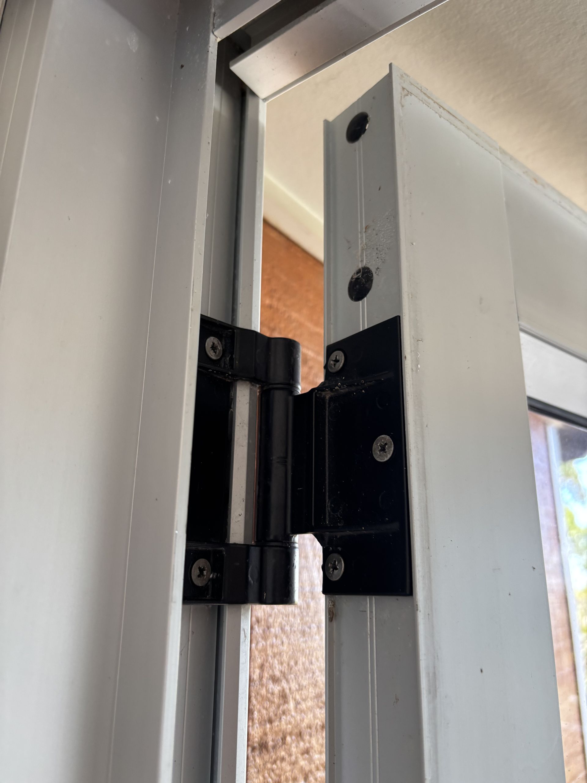 Black Door Hinge Attached To White Metal Door Frame — Fix-A-Door in Terrigal, NSW