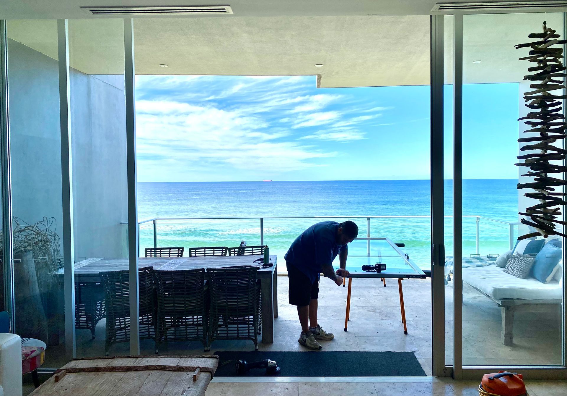 Person Working At A Table On A Patio — Fix-A-Door in Terrigal, NSW
