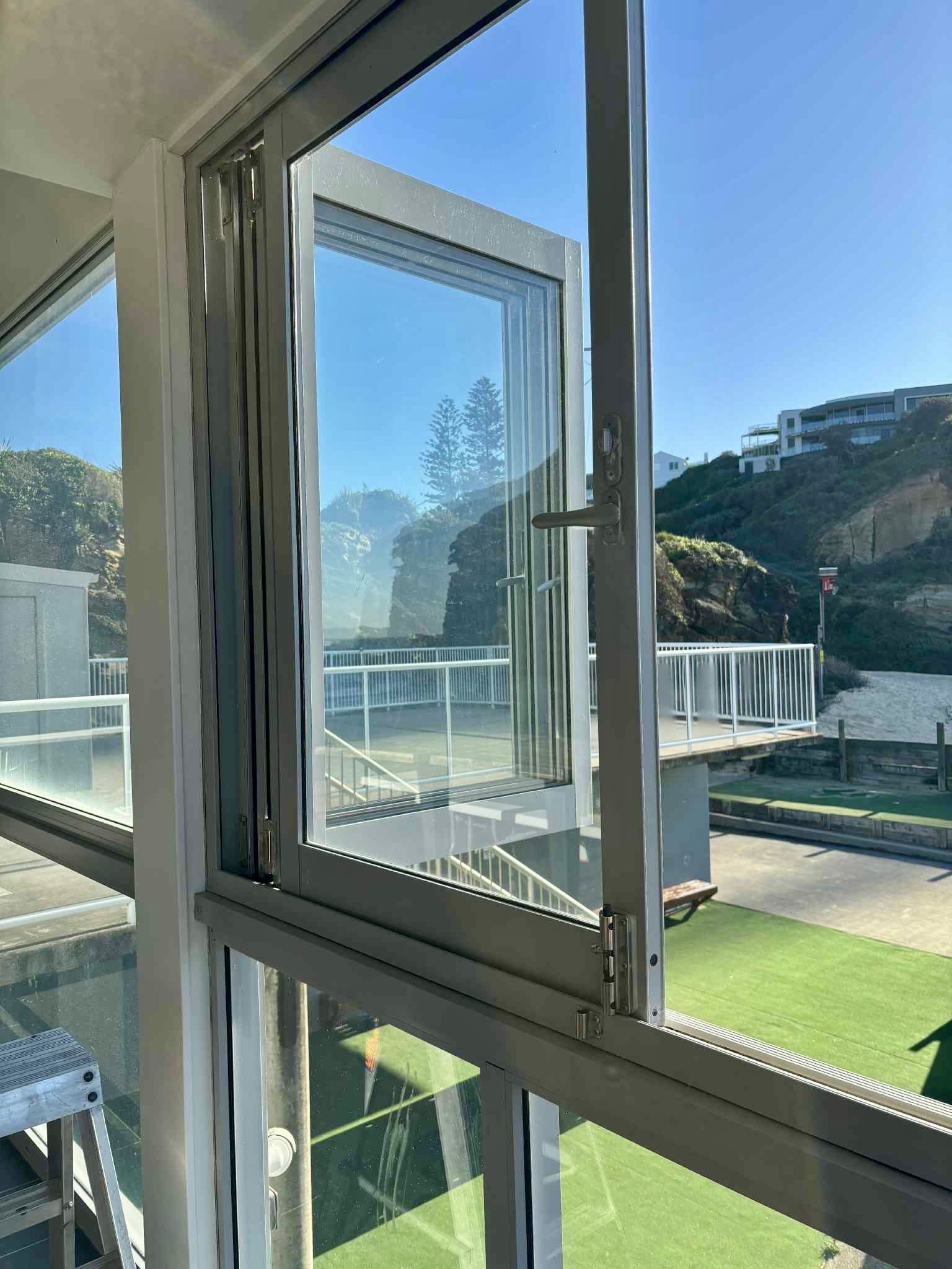 An Open Window Reveals A Coastal View — Fix-A-Door in Terrigal, NSW