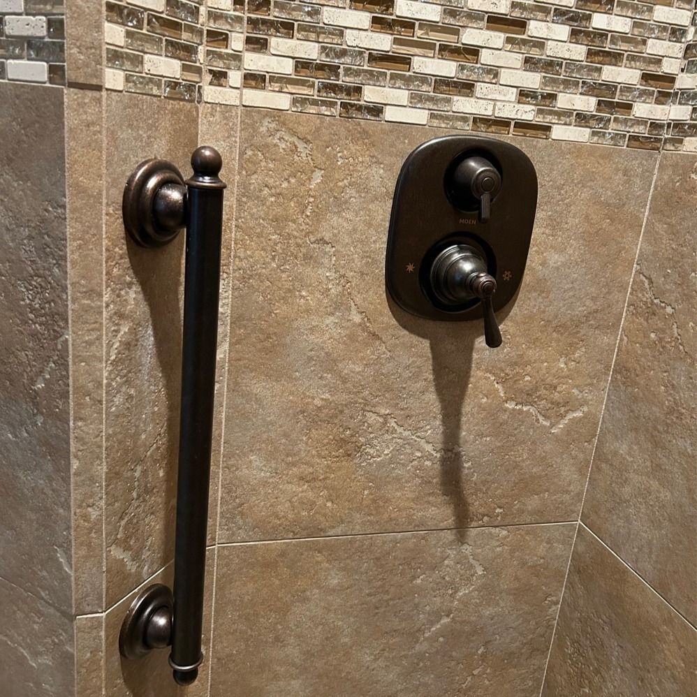 A bathroom with a faucet and a handle on the wall