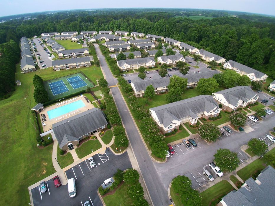 Gallery Photo: view property from drone- all apartments, pool, tennis/ pickleball courts, maintenance building, etc