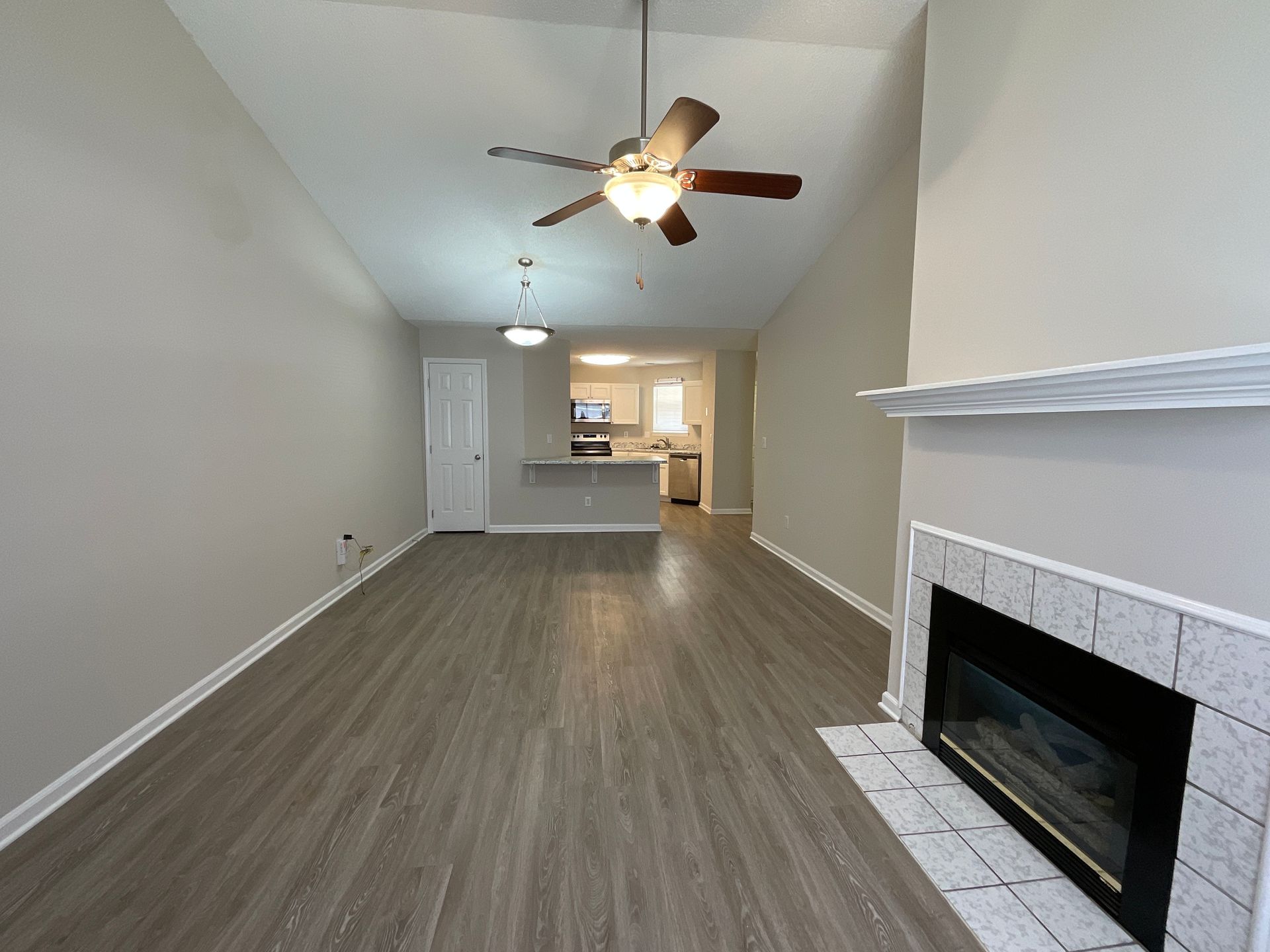Pinnacle 2-Bedroom Living room with Fireplace and view of the Kitchen