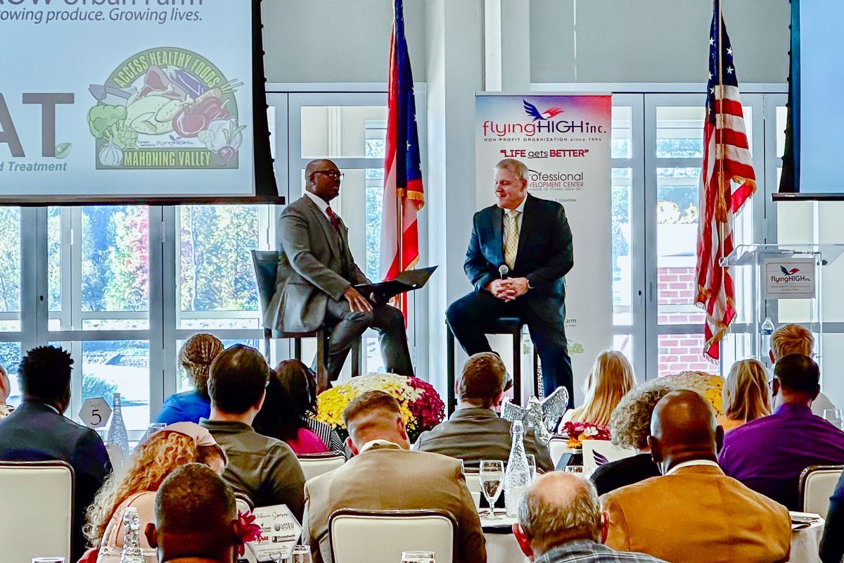DeShawn Scott and Jeff Magada on the stage at Flying High Inc.'s 30 Year anniversary breakfast event. 