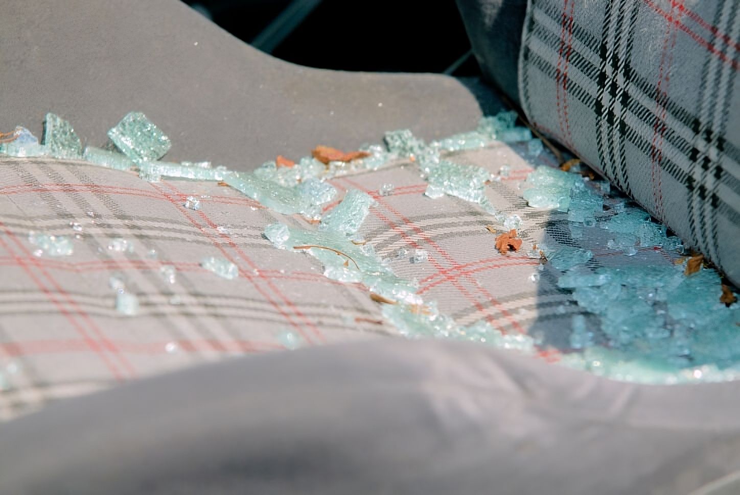 a car seat with a lot of broken glass on it .