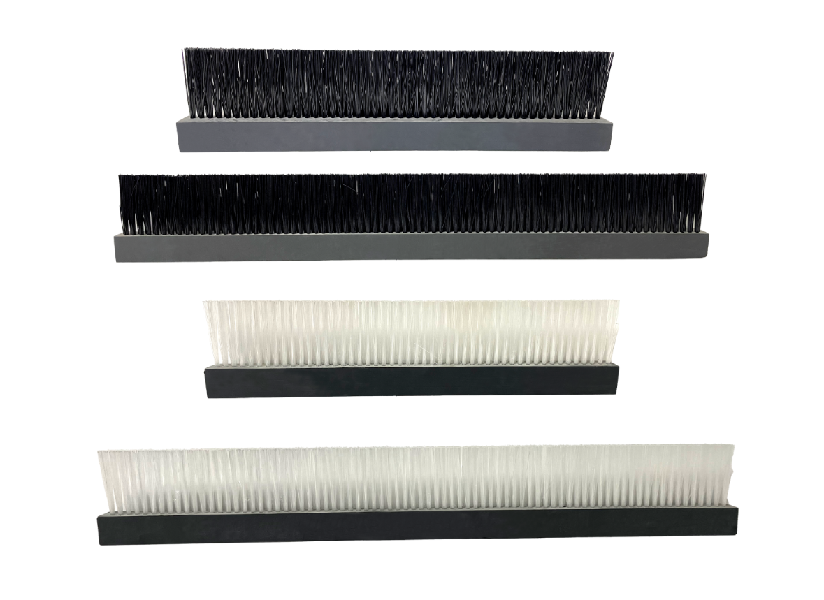 Four rectangular brush strips, two with black bristles, two with white bristles, all on gray or black bases.